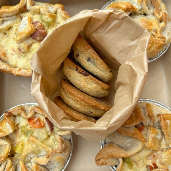 Savory mini pies with flaky crusts and a paper bag filled with sweet pastries from HI Pie Bakery + Cafe.